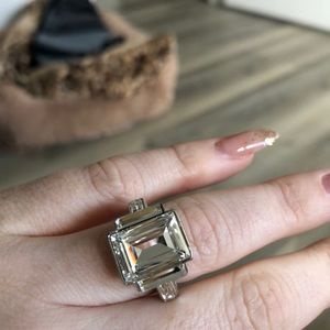 Swarovski. Size 7. I wear size 7.5/8 and it fits